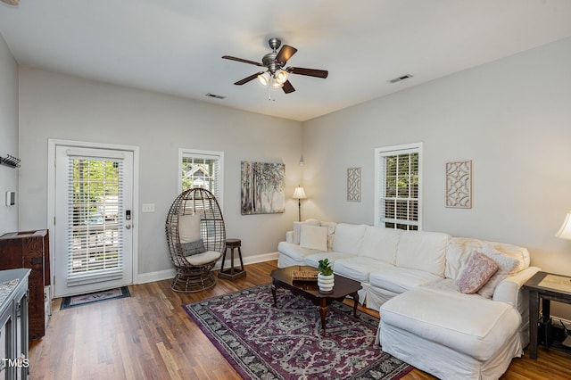 living room featuring dark hardwood / wood-style floors and ceiling fan