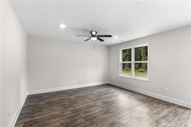 spare room with ceiling fan and dark hardwood / wood-style floors