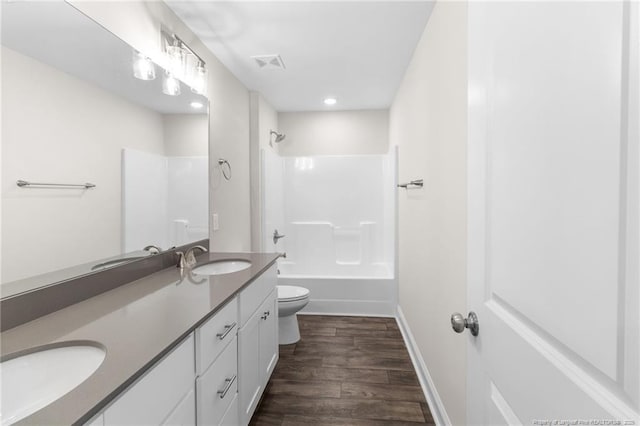 full bathroom with vanity,  shower combination, hardwood / wood-style flooring, and toilet