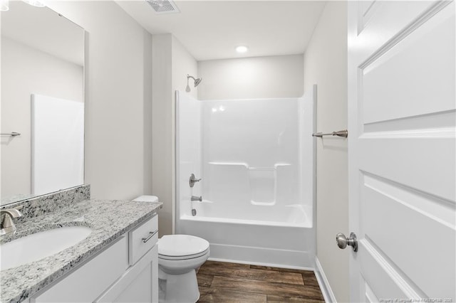 full bathroom featuring toilet, vanity, bathing tub / shower combination, and hardwood / wood-style floors