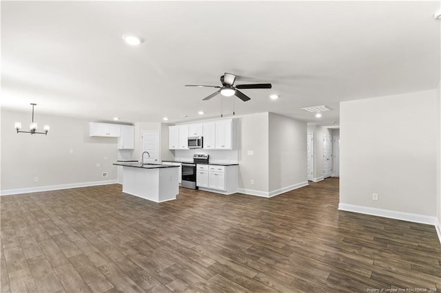 kitchen featuring pendant lighting, stainless steel appliances, ceiling fan with notable chandelier, white cabinets, and sink