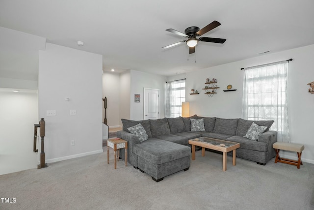 living room with light colored carpet and ceiling fan