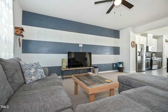 carpeted living room featuring ceiling fan