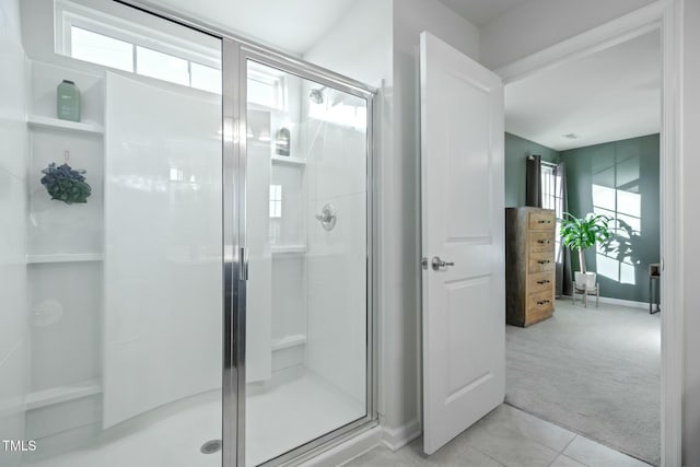 bathroom with tile patterned flooring and a shower with door