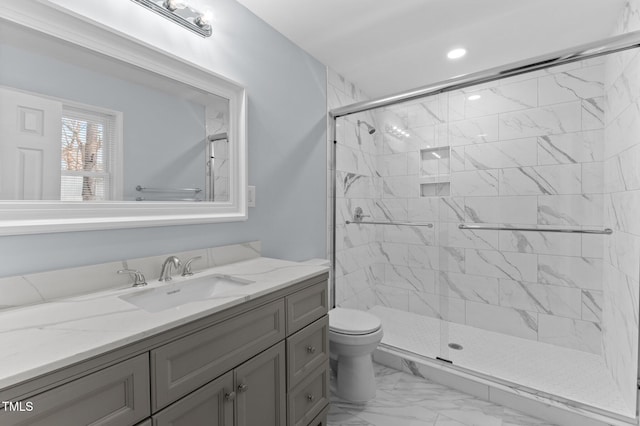 bathroom with vanity, toilet, and an enclosed shower