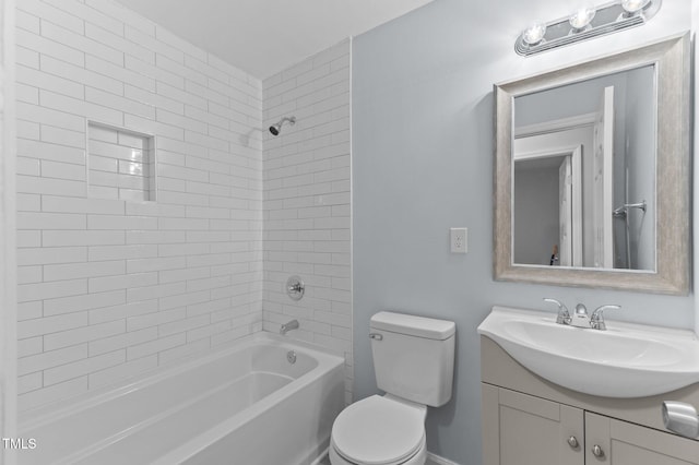 full bathroom featuring tiled shower / bath combo, vanity, and toilet