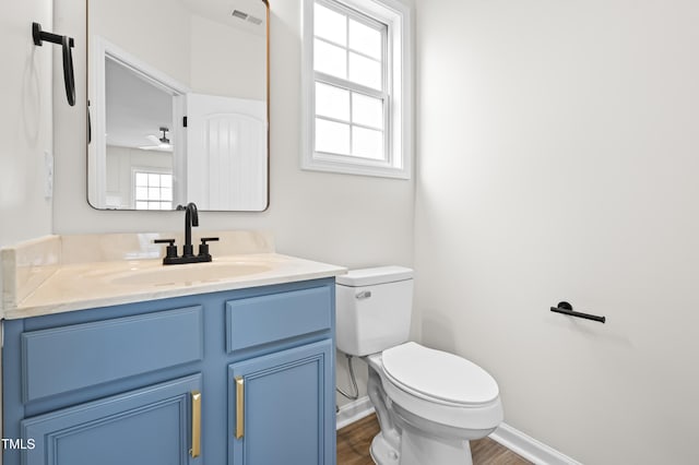 bathroom with toilet, ceiling fan, hardwood / wood-style flooring, and vanity