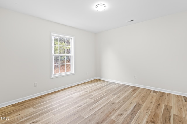 unfurnished room with light wood-type flooring