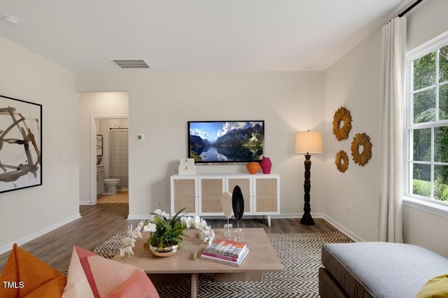 living room with dark hardwood / wood-style flooring and plenty of natural light