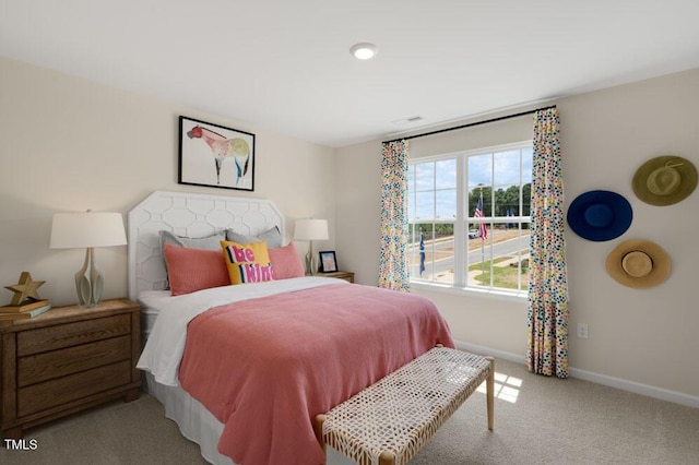 bedroom featuring light carpet