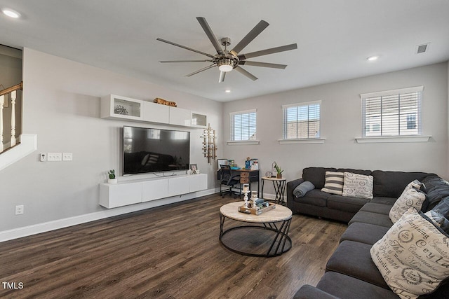 living room with dark wood-type flooring and ceiling fan