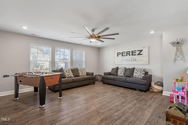 recreation room featuring ceiling fan and dark hardwood / wood-style floors