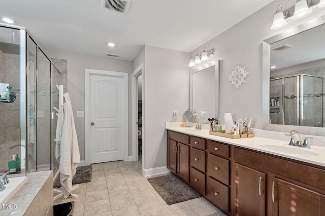 bathroom featuring tile patterned floors, independent shower and bath, and vanity