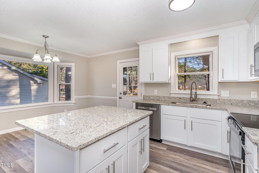 kitchen with dishwasher, black / electric stove, hanging light fixtures, white cabinetry, and sink