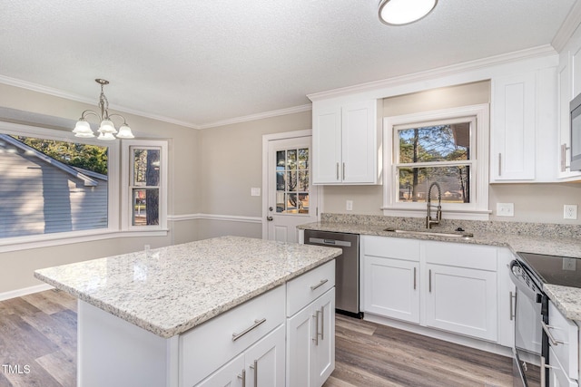 kitchen with dishwasher, black / electric stove, hanging light fixtures, white cabinetry, and sink