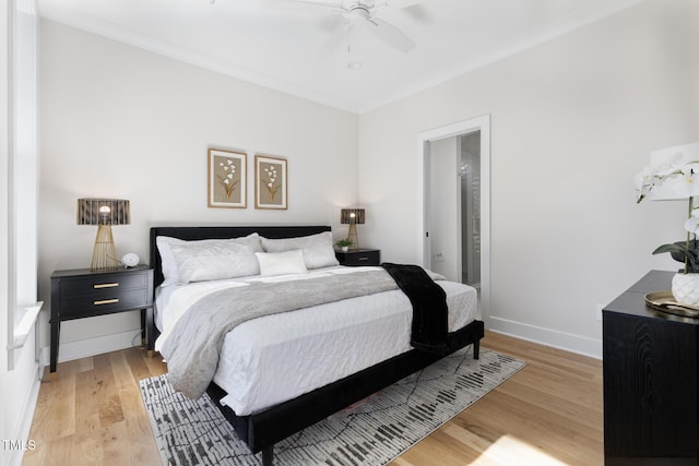 bedroom with ornamental molding, ceiling fan, and light hardwood / wood-style floors