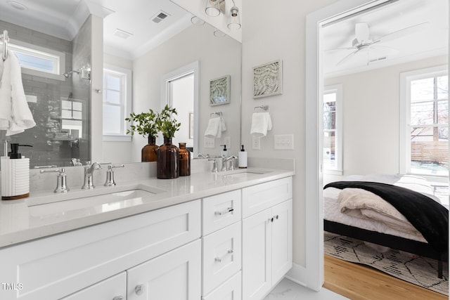 bathroom featuring hardwood / wood-style flooring, walk in shower, crown molding, ceiling fan, and vanity