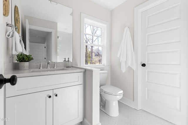 bathroom with tile patterned flooring, vanity, and toilet