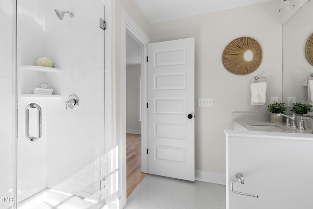 bathroom with vanity and a shower with shower door