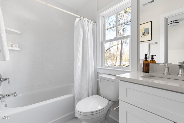 full bathroom featuring toilet, shower / tub combo with curtain, and vanity