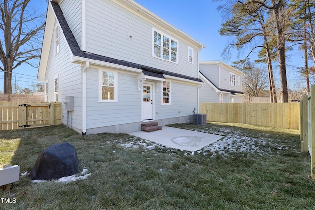 rear view of house featuring a patio and a lawn