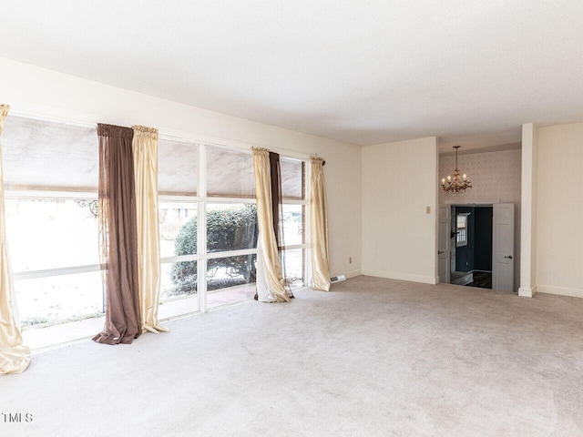 unfurnished living room featuring carpet floors and a notable chandelier