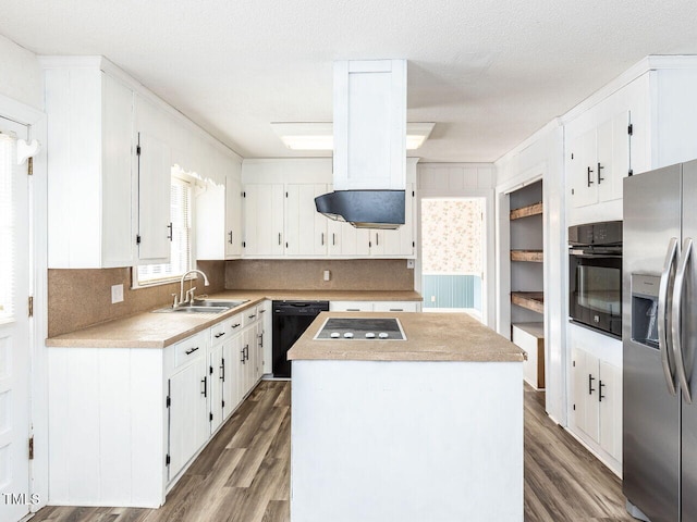 kitchen featuring white cabinetry, a center island, tasteful backsplash, black appliances, and sink