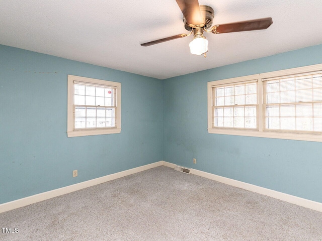 spare room with carpet and ceiling fan