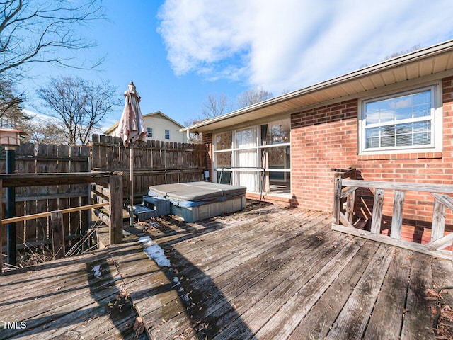 wooden deck featuring a covered hot tub