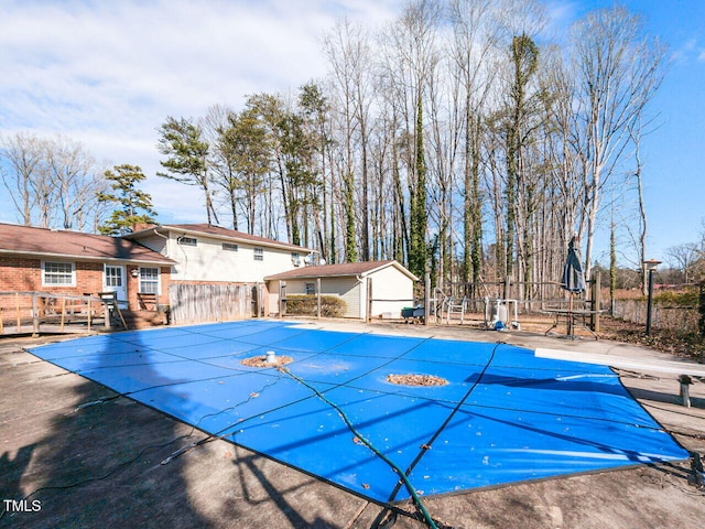 view of pool featuring a diving board and an outdoor structure