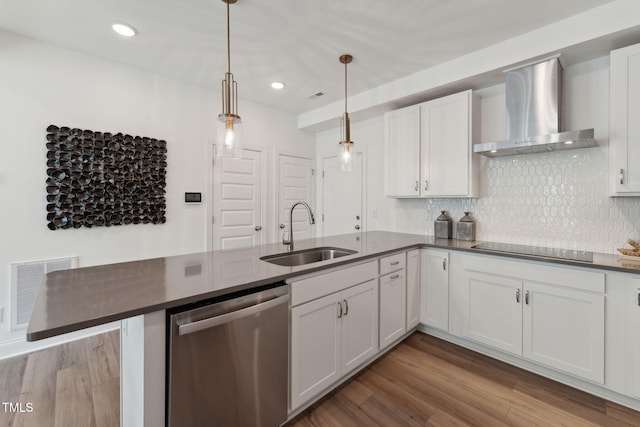 kitchen featuring dishwasher, pendant lighting, wall chimney exhaust hood, sink, and white cabinetry