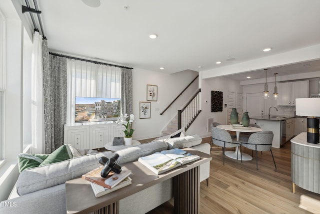 living room featuring sink and light wood-type flooring