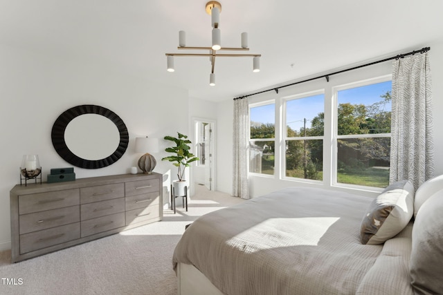 carpeted bedroom with a chandelier