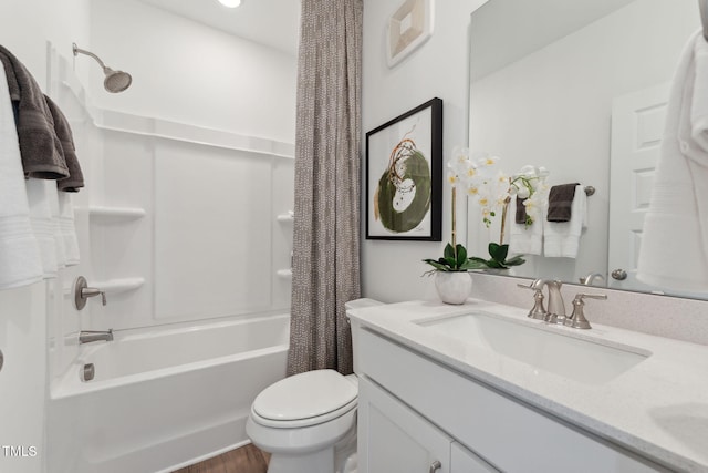 full bathroom featuring vanity, shower / bath combo with shower curtain, and toilet