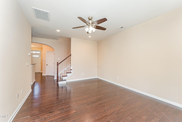 spare room with dark wood-type flooring and ceiling fan