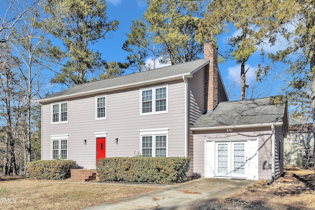 colonial home with a front lawn