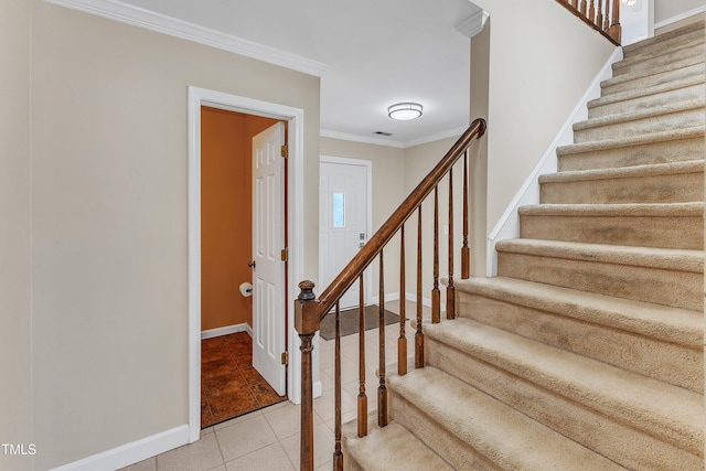 staircase featuring tile patterned flooring and ornamental molding