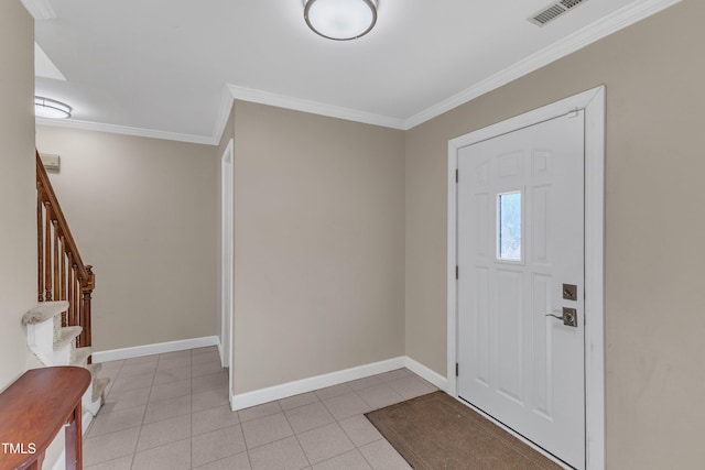 tiled entryway featuring crown molding