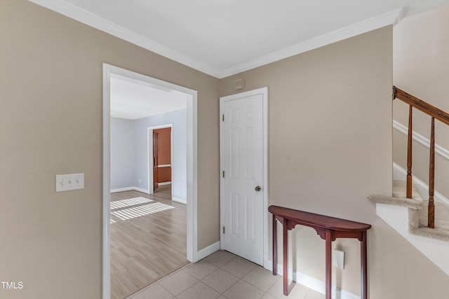 hall with light tile patterned floors and ornamental molding