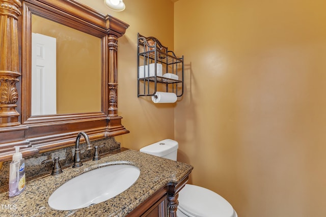 bathroom featuring toilet and vanity