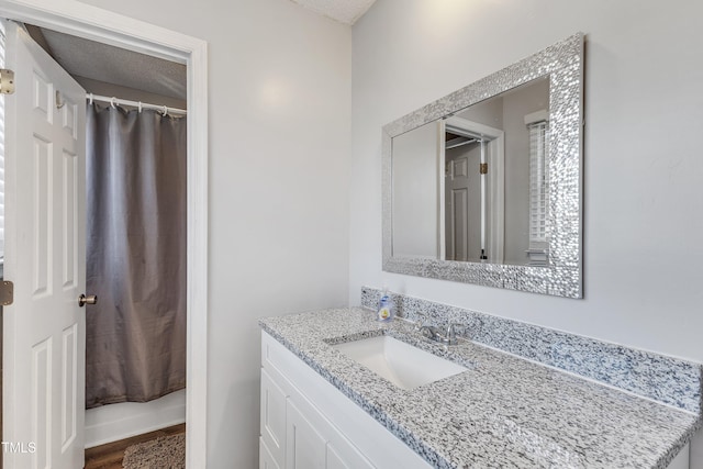 bathroom with hardwood / wood-style floors and vanity