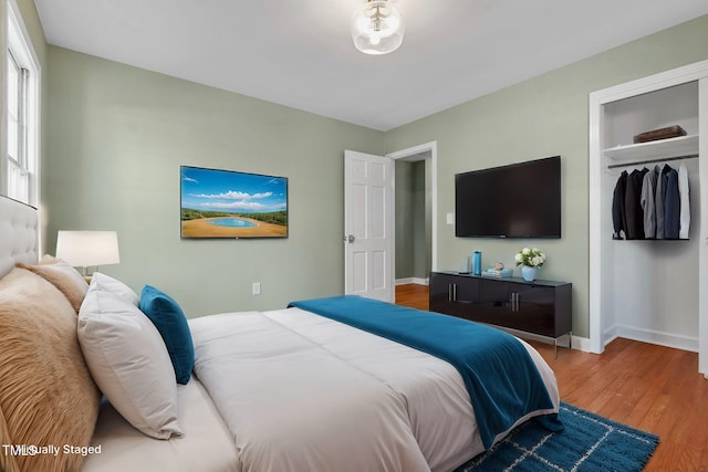 bedroom featuring hardwood / wood-style floors and a closet