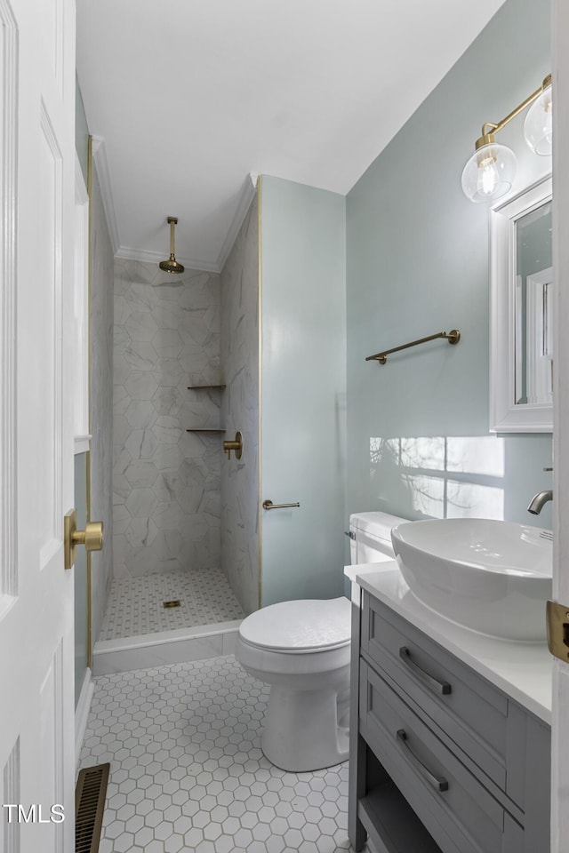 bathroom featuring vanity, tile patterned floors, toilet, and walk in shower