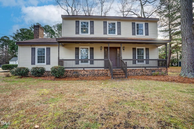 view of front facade featuring covered porch and a front lawn