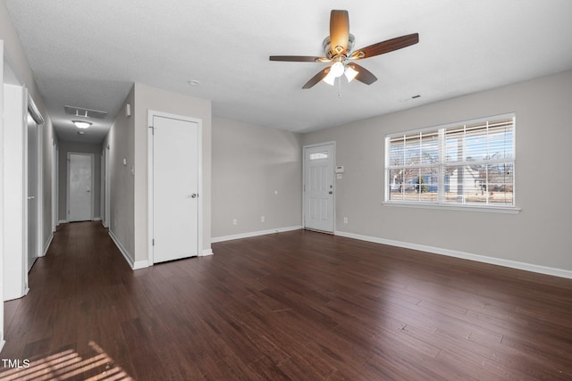 unfurnished room featuring ceiling fan and dark hardwood / wood-style floors