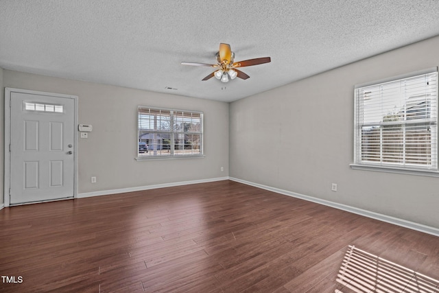 entrance foyer featuring ceiling fan, dark hardwood / wood-style flooring, and a textured ceiling