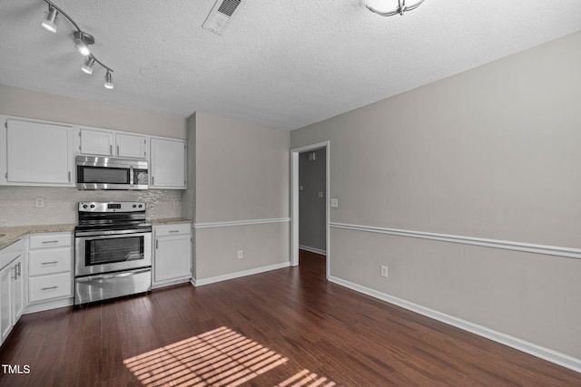 kitchen featuring white cabinetry, appliances with stainless steel finishes, backsplash, and dark hardwood / wood-style flooring