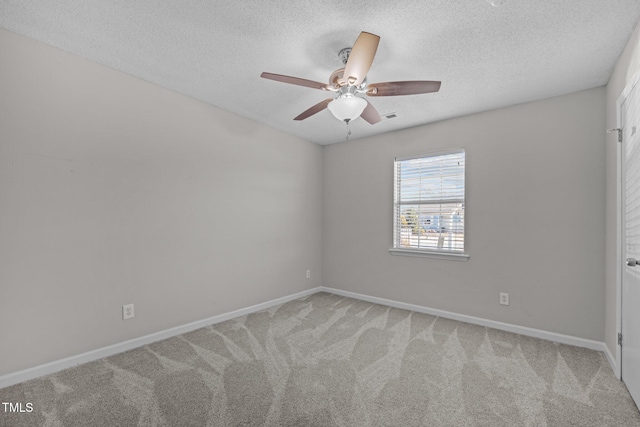 carpeted empty room featuring a textured ceiling and ceiling fan