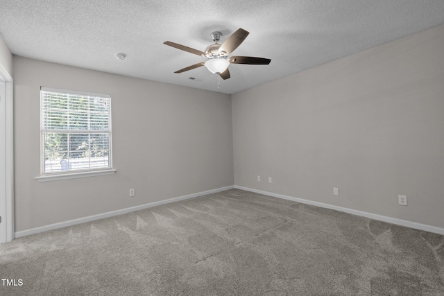 spare room featuring ceiling fan, carpet flooring, and a textured ceiling