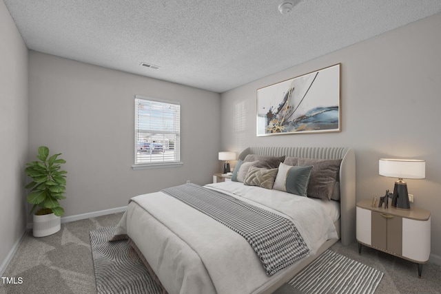 bedroom with carpet floors and a textured ceiling